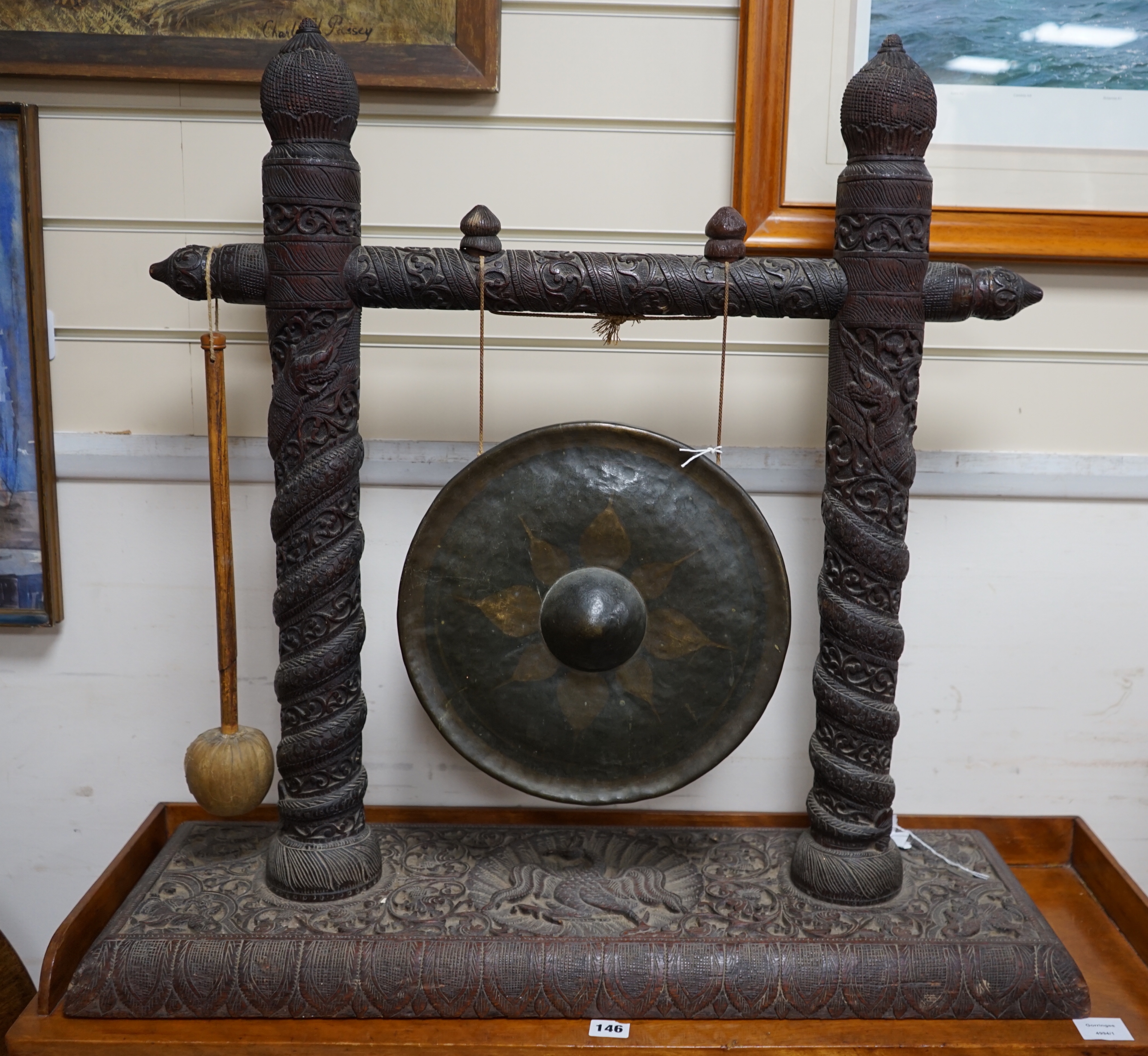 An Indian hardwood framed dinner gong